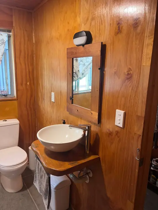 Timber lined bathroom with vessel basin