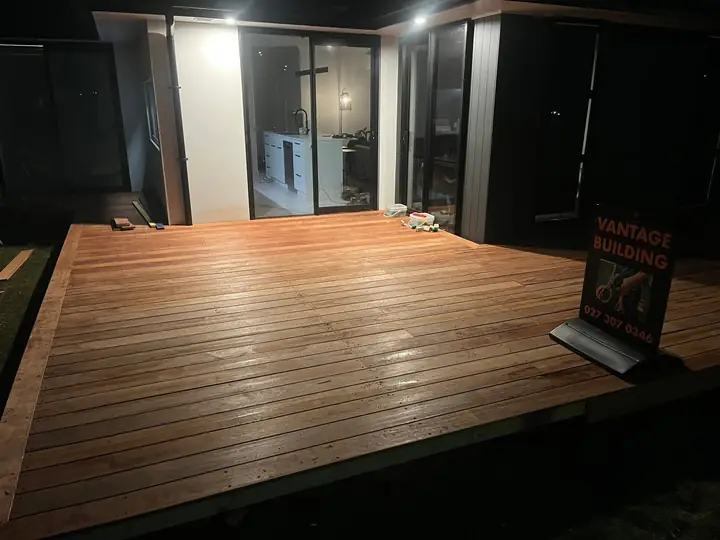 Oiled deck at night with Vantage Building sign