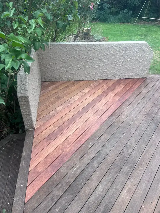 Hardwood deck boards next to a plaster wall