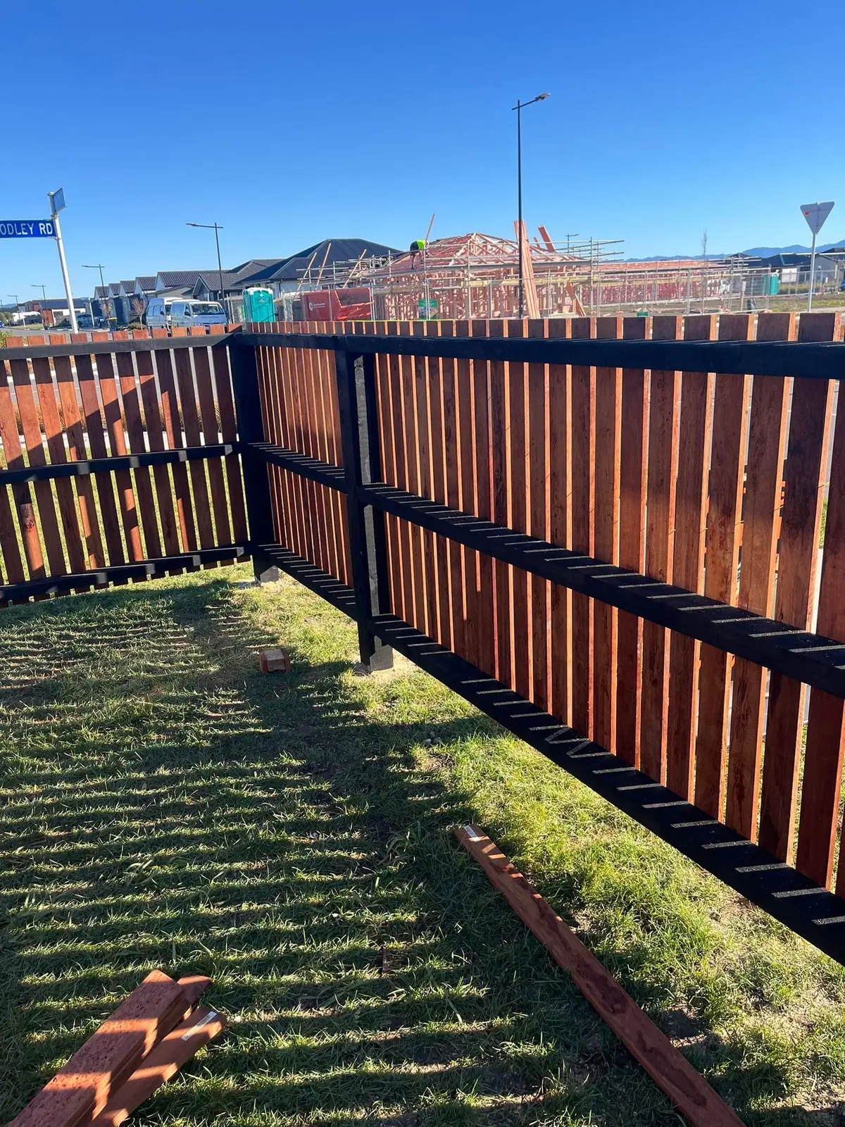 Corner timber fence with black rails